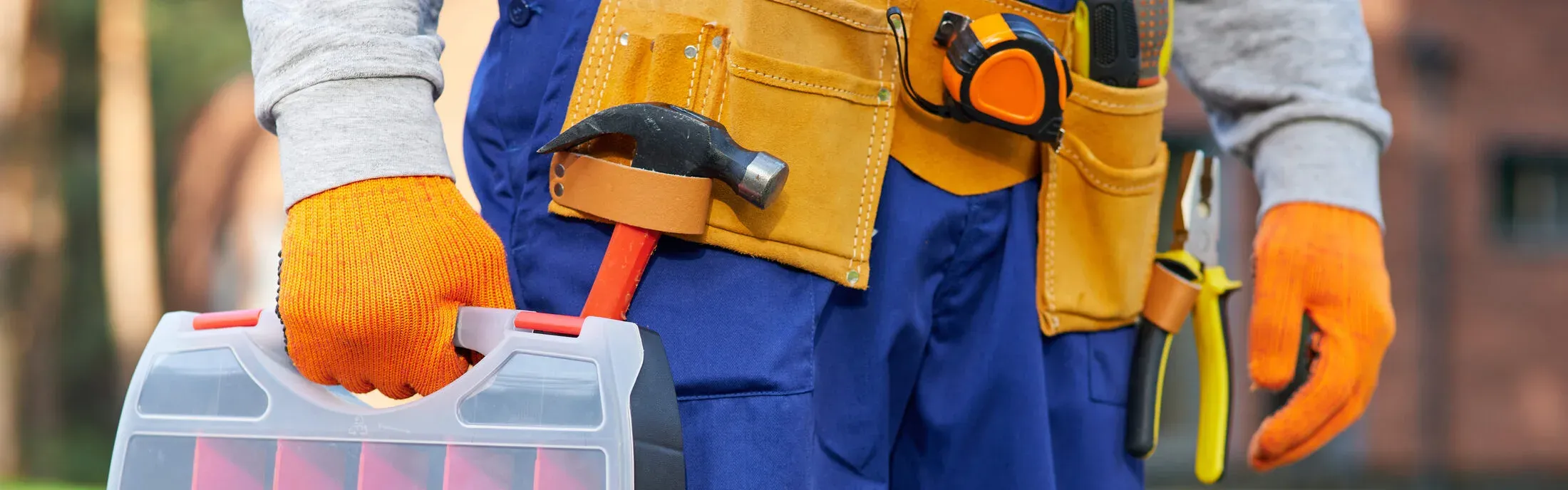 A plumber's tool belt and hand tools, the kind of equipment a licensed local plumber brings to a repair call